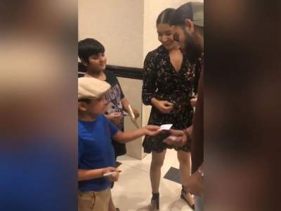 7 YEAR OLD BOY OFFERING HIS AUTO GRAPH TO VIRAT AND ANUSKHA